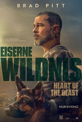 Filmplakat zu „Eiserne Wildnis – Heart of the Beast“: Vor einer rauen, weitläufigen Landschaft ist ein bärtiger Mann im Seitenprofil zu sehen, der mit ernstem Blick in die Ferne schaut. Im Vordergrund steht ein Schäferhund, ebenfalls seitlich dargestellt und aufmerksam nach vorne blickend.