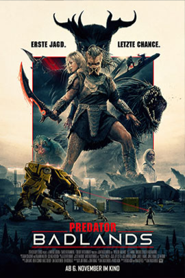Filmplakat für Predator: Badlands – Eine gepanzerte Kriegerfigur mit leuchtender Klinge steht im Zentrum, neben ihr eine entschlossene Frau. Hinter ihnen erscheinen monströse Kreaturen und eine futuristische Landschaft mit Maschinen. Darüber steht Erste Jagd. Letzte Chance., unten der Titel Predator: Badlands und das Datum Ab 6. November im Kino.