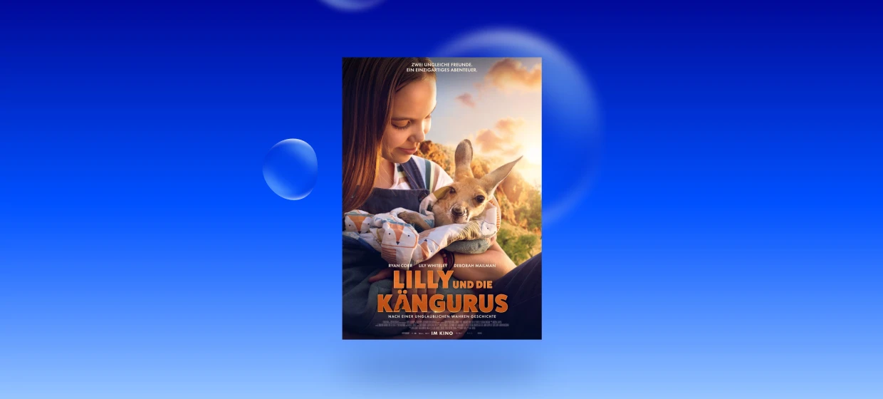  Filmplakat des Films LILLY UND DIE KÄNGURUS. Die lächelnde Hauptdarstellerin hält ein Känguru-Junges im Arm, welches in einer Decke eingehüllt ist. Im unteren Bereich des Filmplakats sind die Namen der Schauspieler zu lesen: Ryan Corr, Lily Whiteley, Deborah Mailman. Zudem steht im unteren Bereich des Filmplakats: LILLY UND DIE KÄNGURUS NACH EINER UNGLAUBLICHEN WAHREN GESCHICHTE 