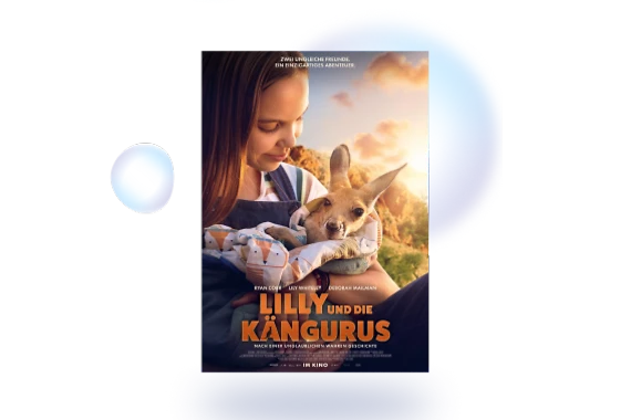  Filmplakat des Films LILLY UND DIE KÄNGURUS. Die lächelnde Hauptdarstellerin hält ein Känguru-Junges im Arm, welches in einer Decke eingehüllt ist. Im unteren Bereich des Filmplakats sind die Namen der Schauspieler zu lesen: Ryan Corr, Lily Whiteley, Deborah Mailman. Zudem steht im unteren Bereich des Filmplakats: LILLY UND DIE KÄNGURUS NACH EINER UNGLAUBLICHEN WAHREN GESCHICHTE 