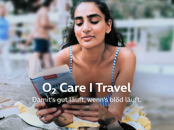  Eine Frau liest ein entspannt ein Buch am Strand.
